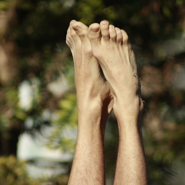 Man stretching outdoors with a serene natural background.